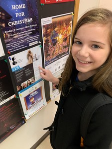 Tessa posing with the poster for the LCO performance.